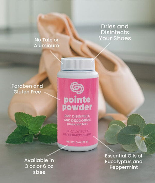 Pink bottle of pointe powder with text highlighting its features, surrounded by eucalyptus leaves.