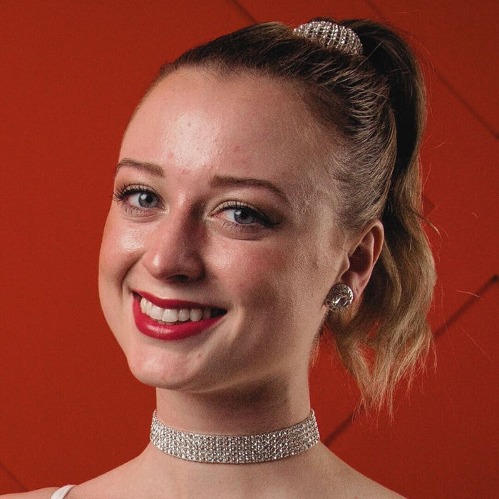 Woman wearing a sparkling choker against a red background