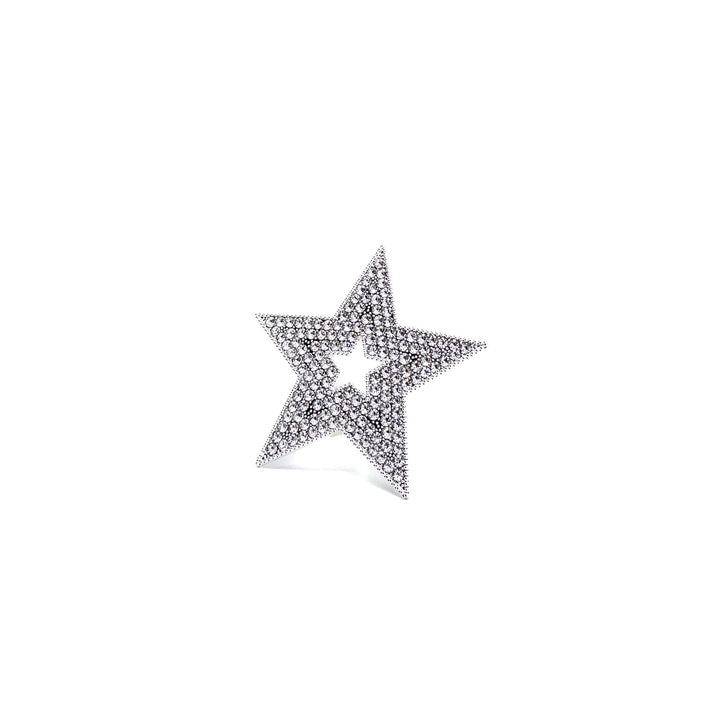 Star-shaped jewelry piece with embedded stones on a white background