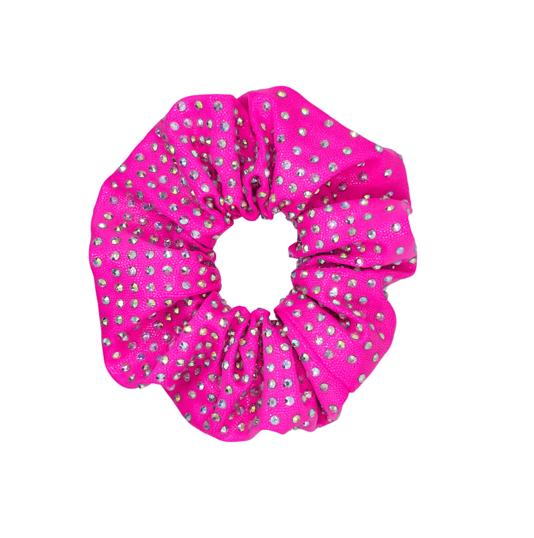 Pink scrunchie with white polka dots on a white background
