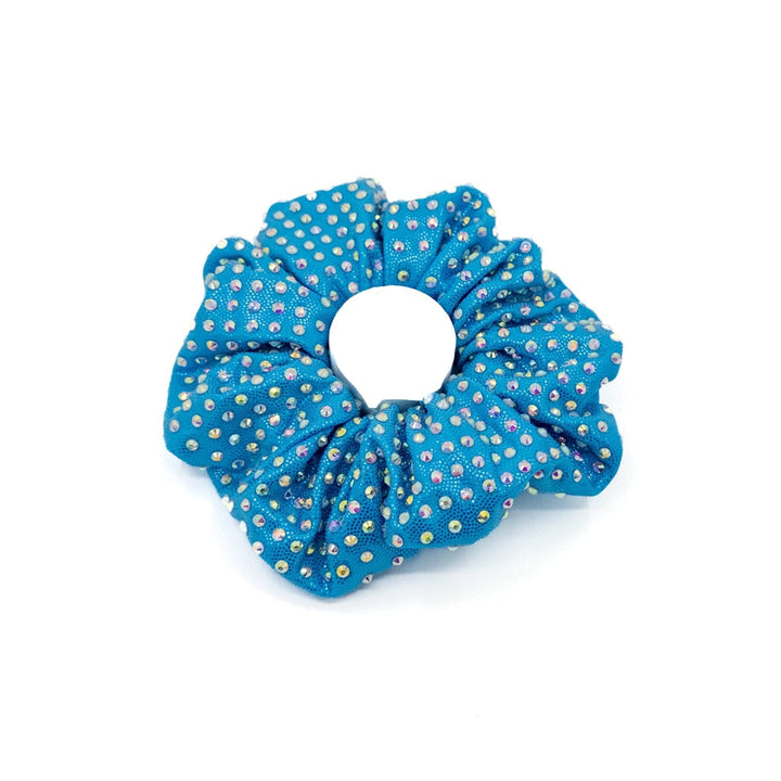 Blue scrunchie with gold polka dots on a white background