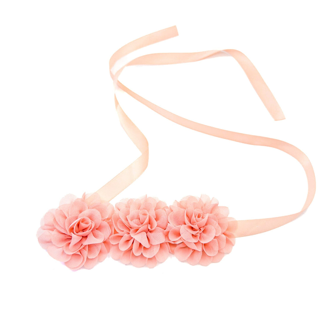 Pink floral headband with a plain background