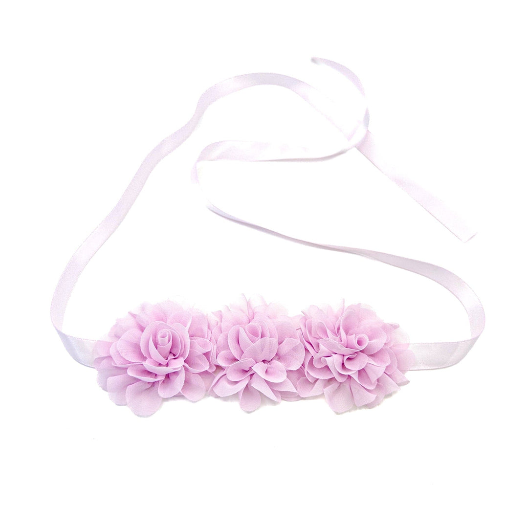 Pink floral headband on a white background