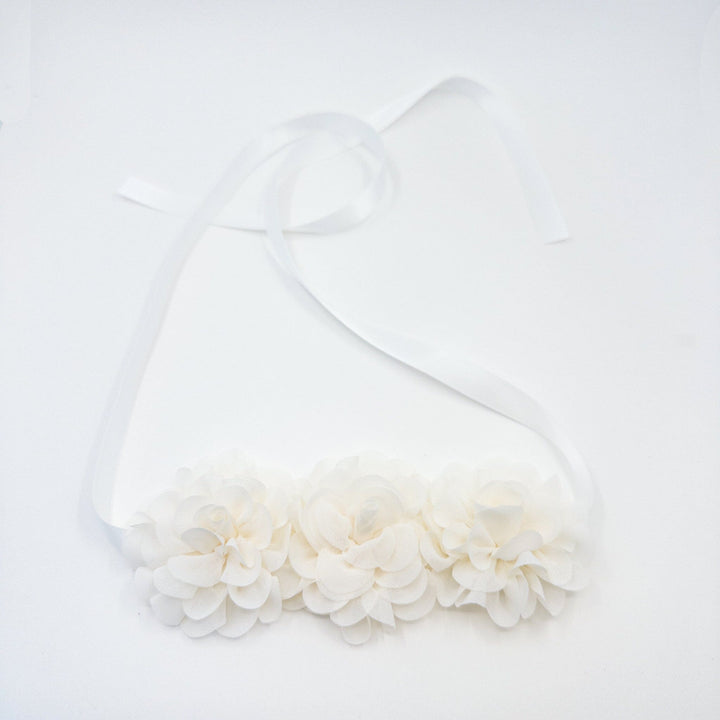 White dress with a large bow on a white background