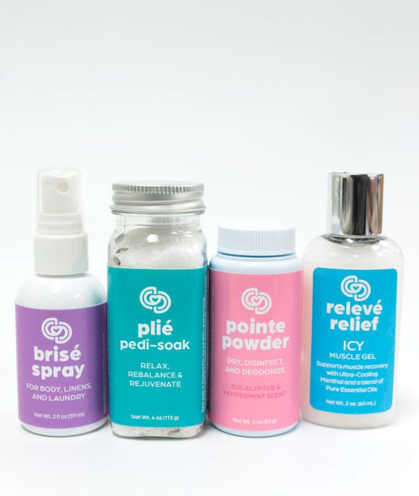Four bottles of different products with colorful labels on a white background