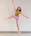 Dancer in a colorful top and purple leggings posing against a plain background