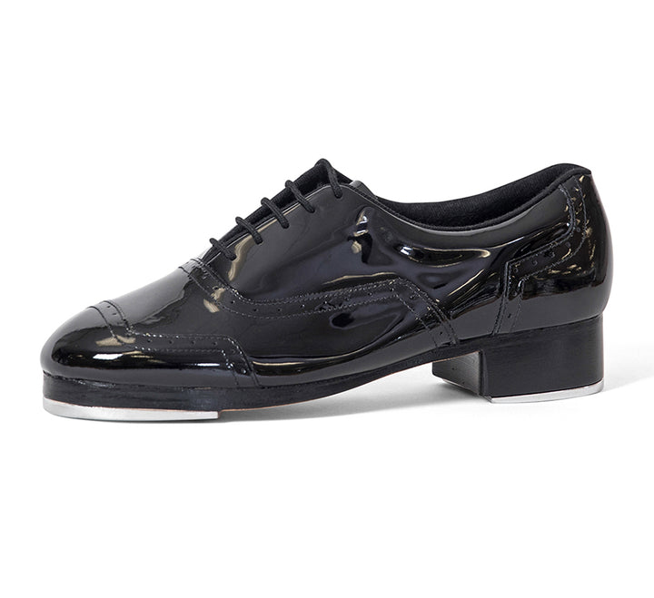 Black patent leather tap shoe on a white background