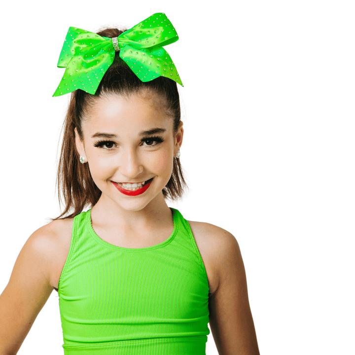 Person wearing a bright green outfit with a large green bow on a white background