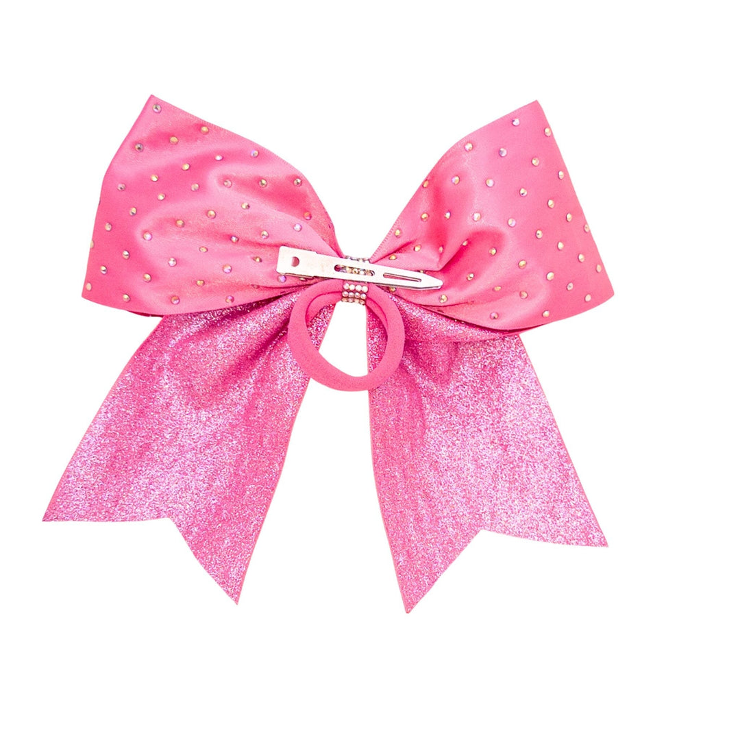 Pink glittery hair bow with a clip on a white background