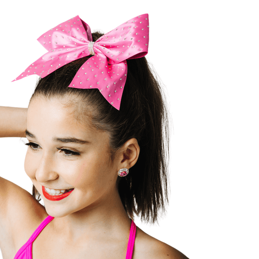Girl with a large pink polka dot bow in her hair on a white background