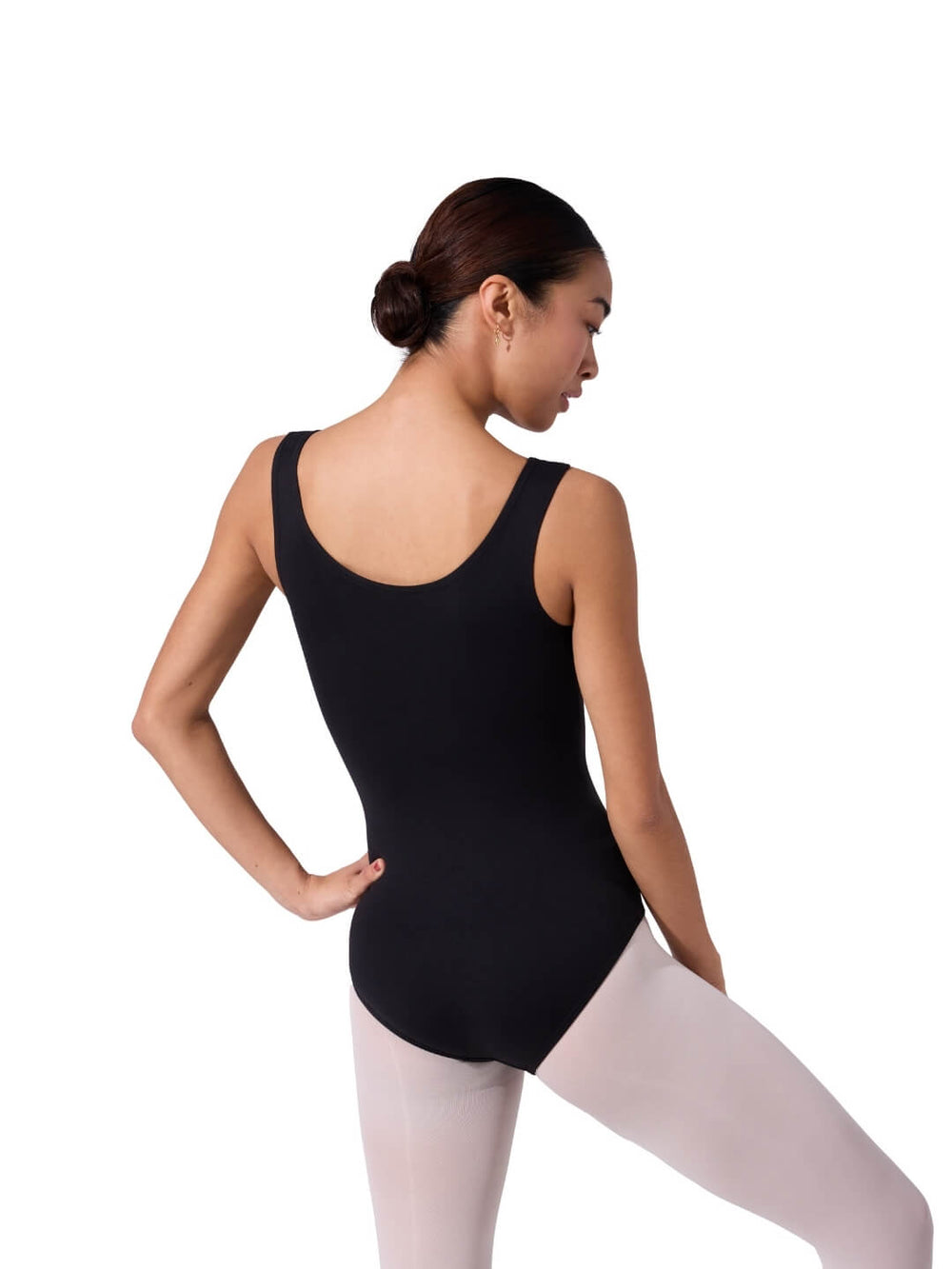 Person wearing a black leotard and white tights on a white background