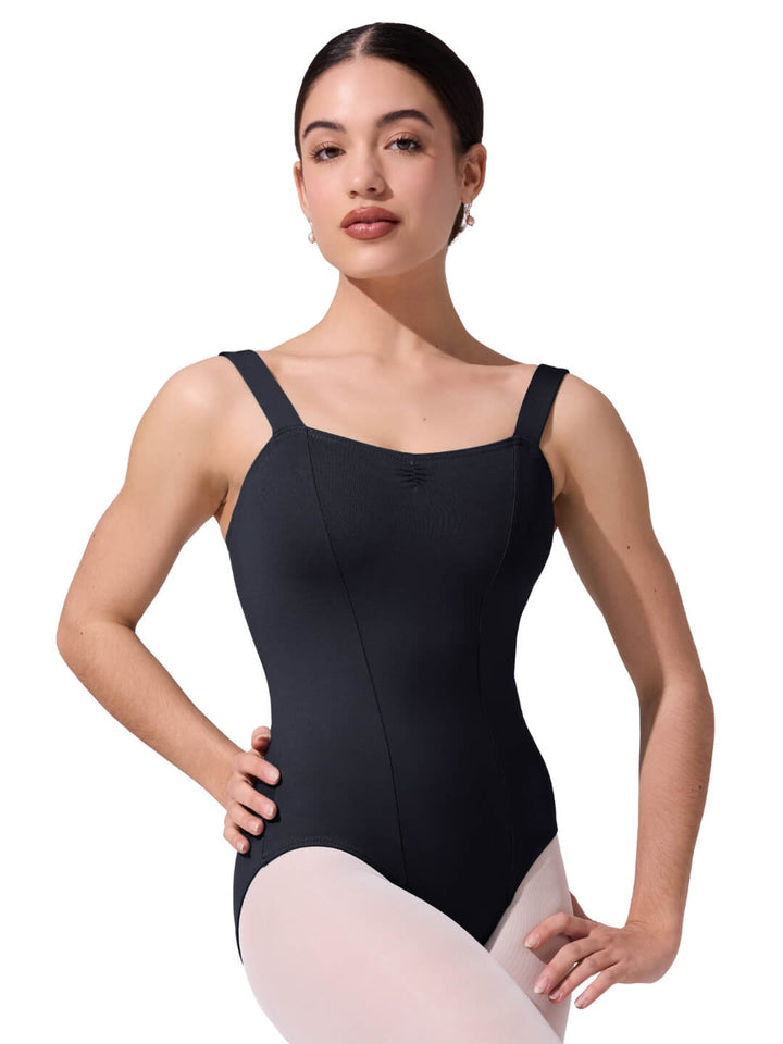Woman wearing a black leotard on a white background