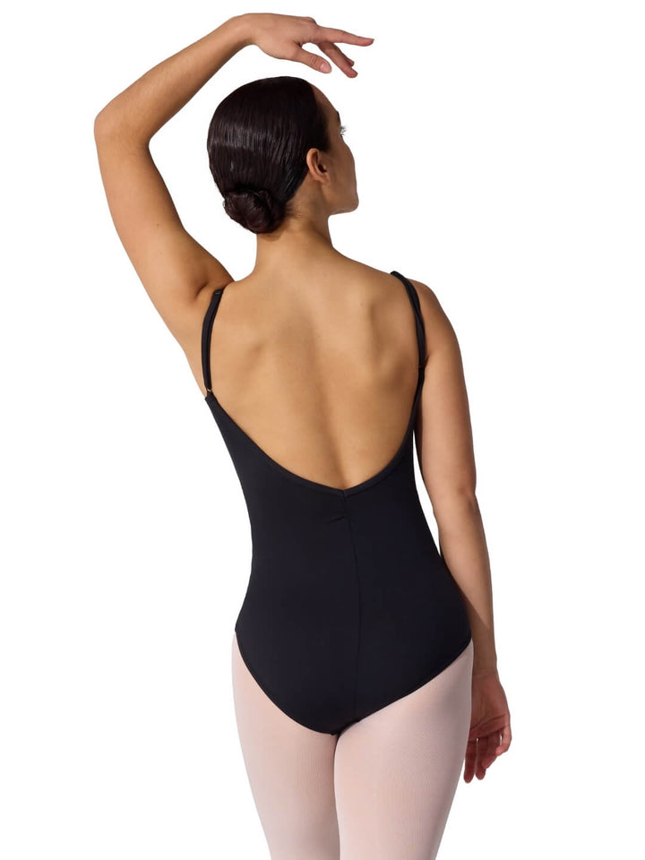 Woman wearing a black leotard on a white background