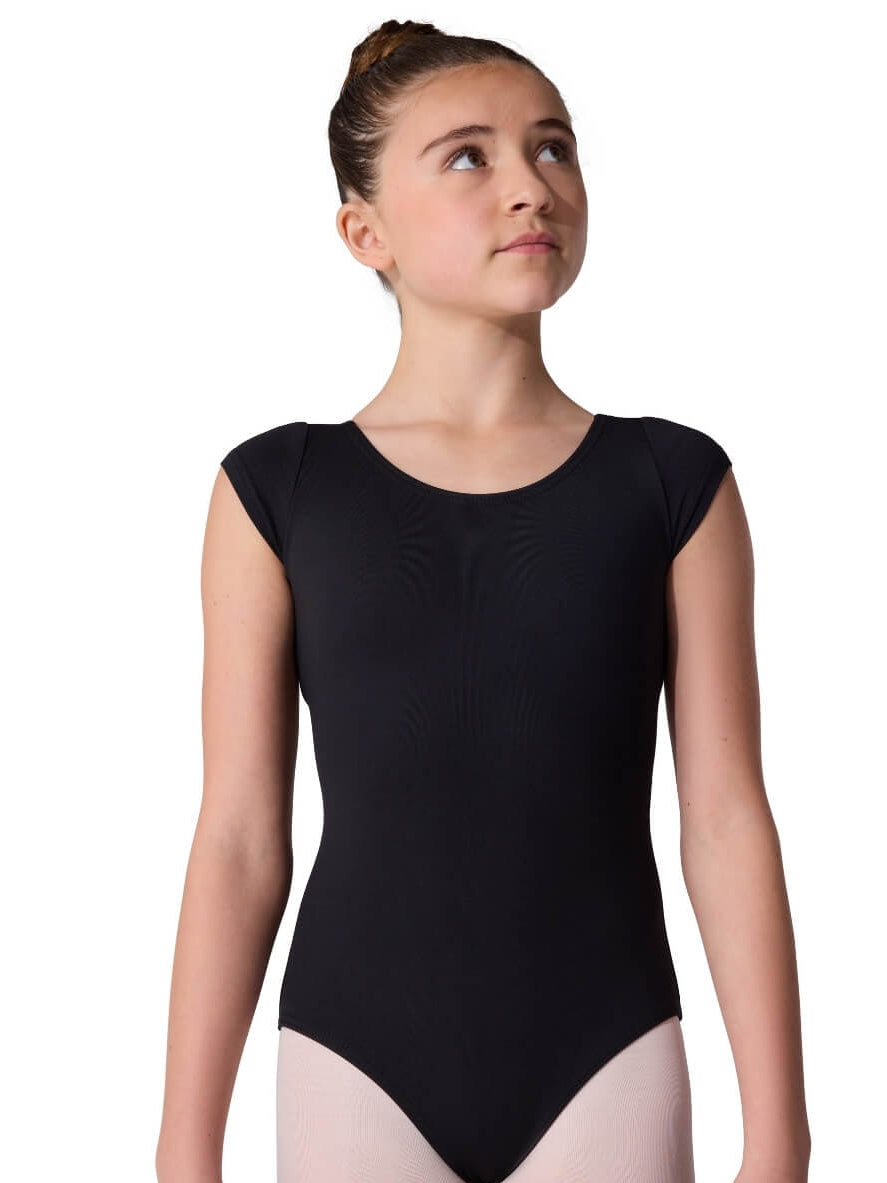 Young girl wearing a black cap-sleeve leotard on a white background