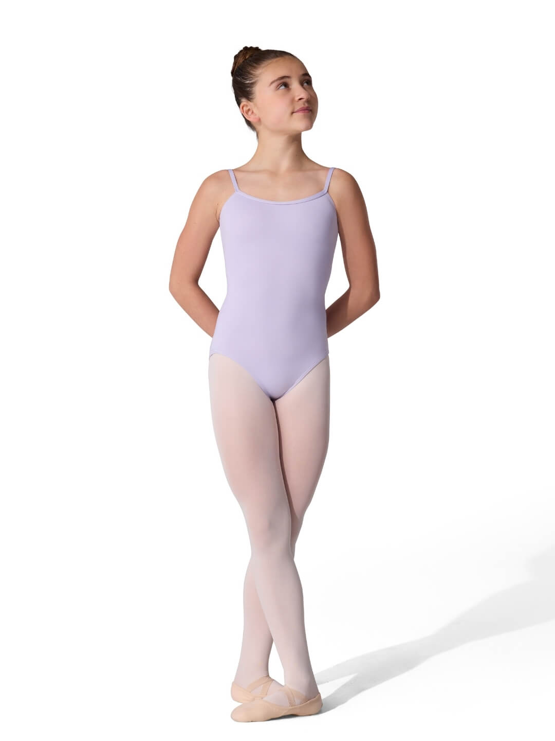 Ballerina in a lavender leotard and pink tights on a white background