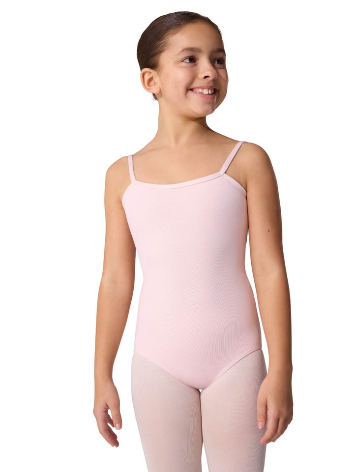 Young girl wearing a pink leotard on a white background