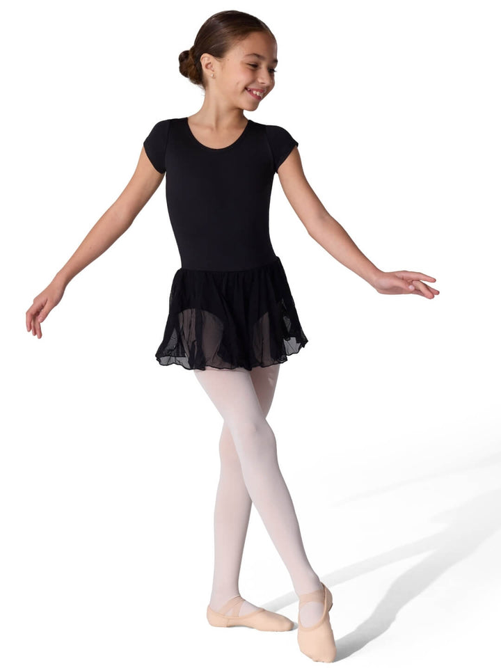 Young girl in a black ballet outfit with a sheer skirt on a white background