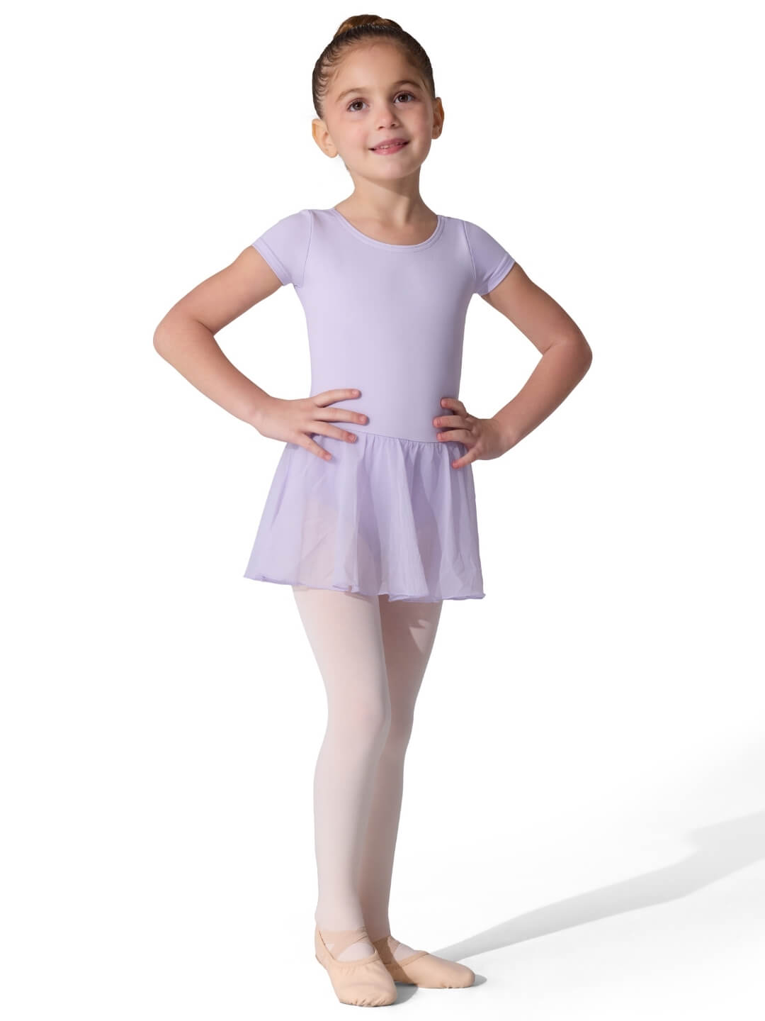 Young girl in a purple ballet dress posing on a white background