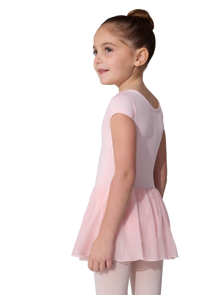 Young girl wearing a pink ballet dress on a white background