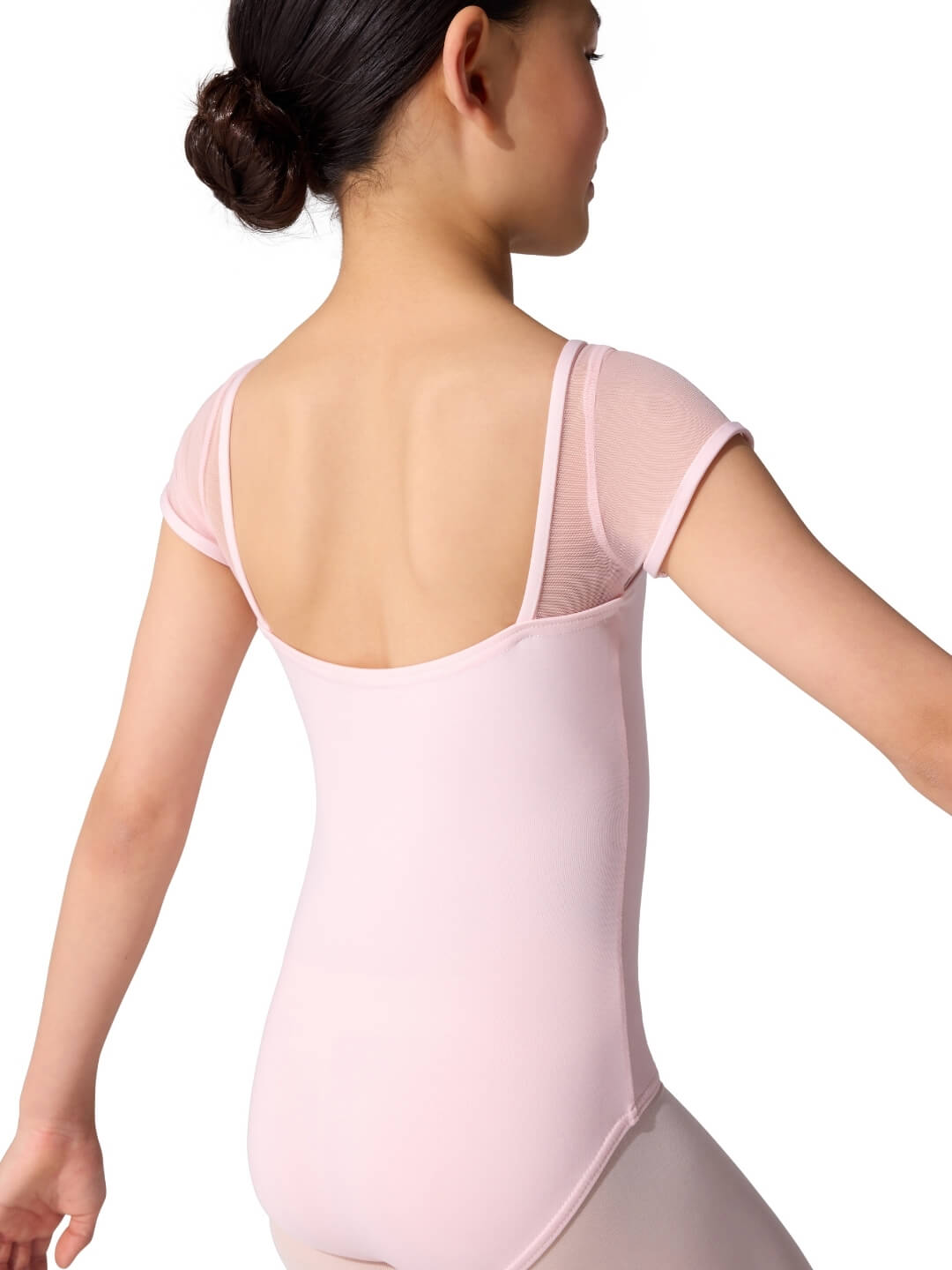 Person wearing a pink leotard on a white background