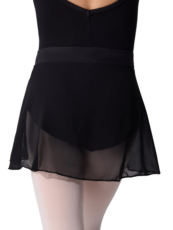 Black skirt with sheer overlay worn over a black leotard on a white background