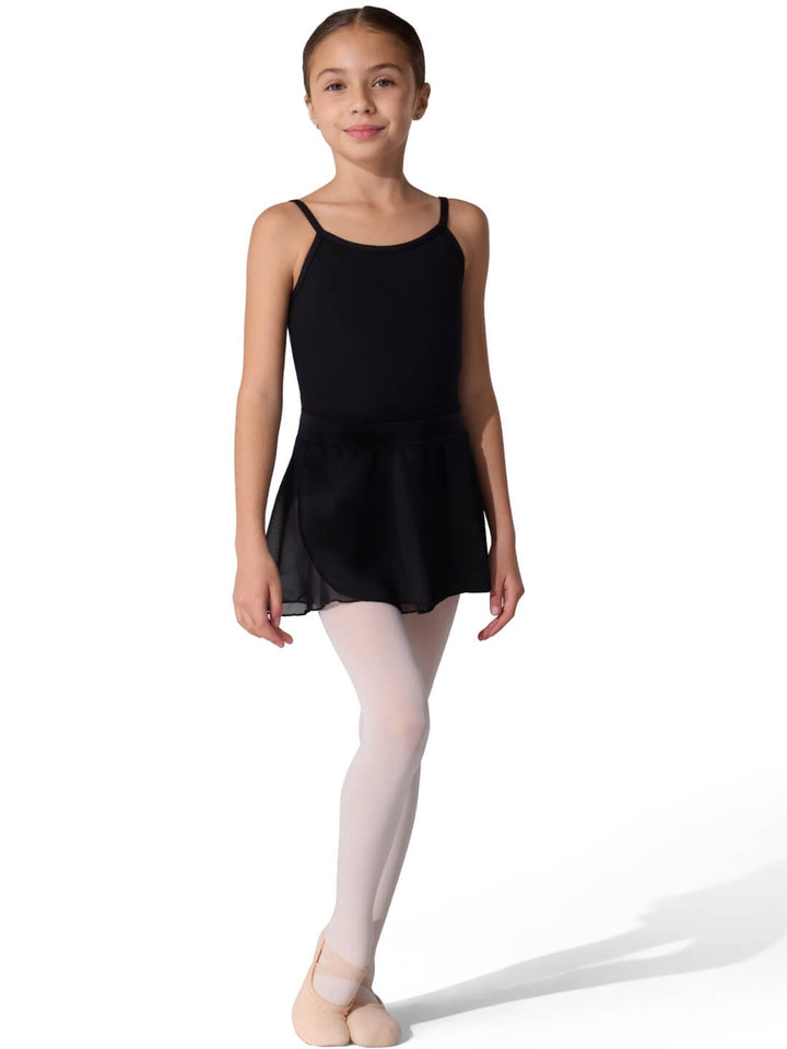 Young girl in a black leotard and white tights on a white background