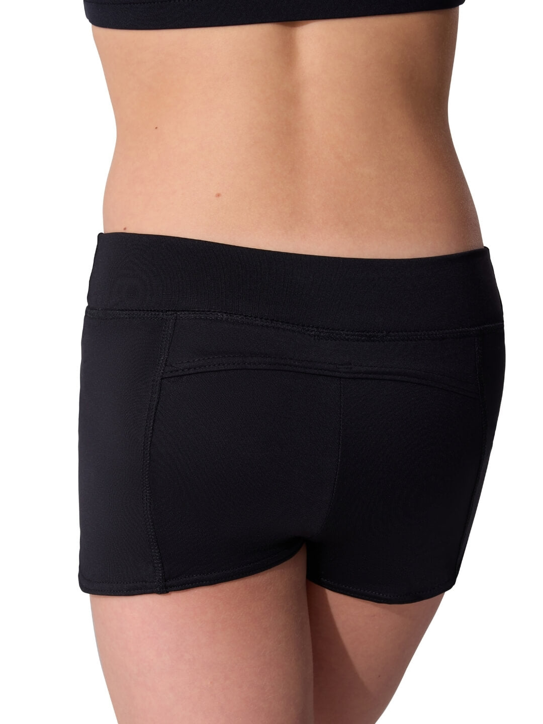 Black athletic shorts worn by a person on a white background
