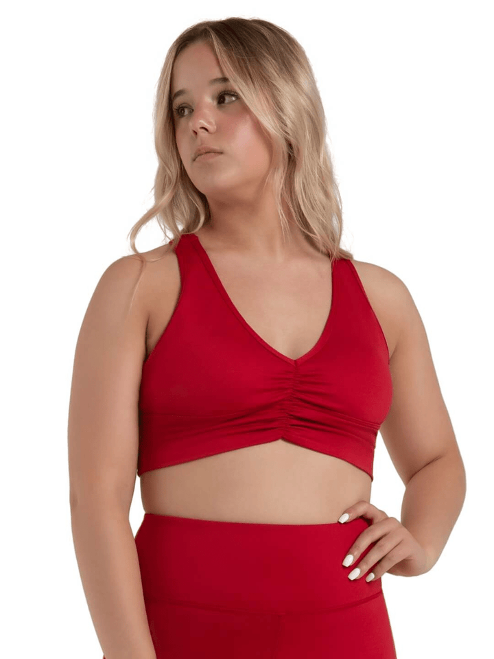 Woman wearing a red halter top and skirt on a white background