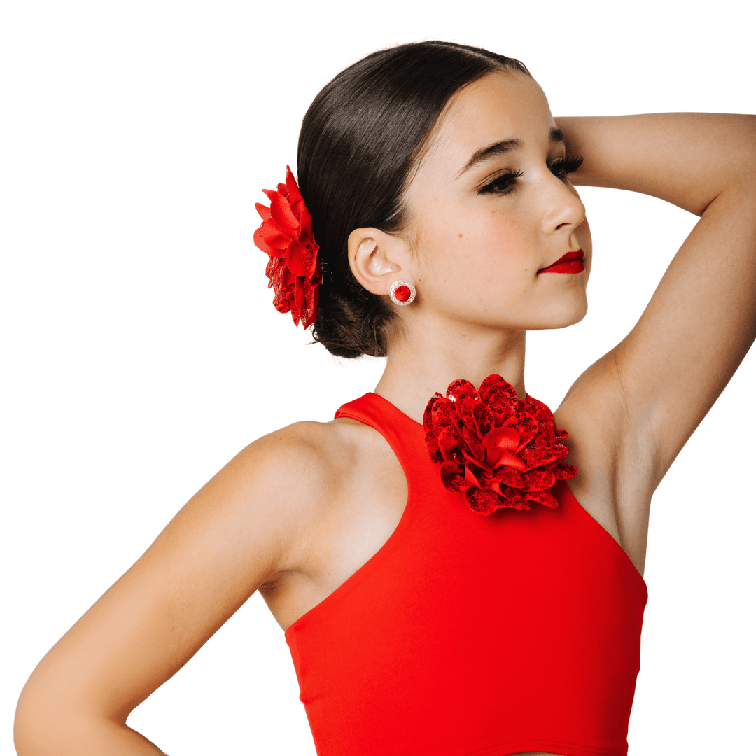 Woman wearing a red dress with floral accessories on a white background