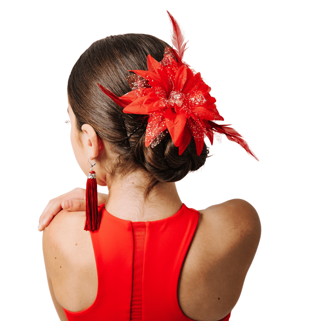 Woman wearing a red dress with a decorative hairpiece on a white background