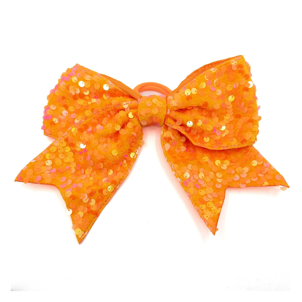Orange sequin bow on a white background