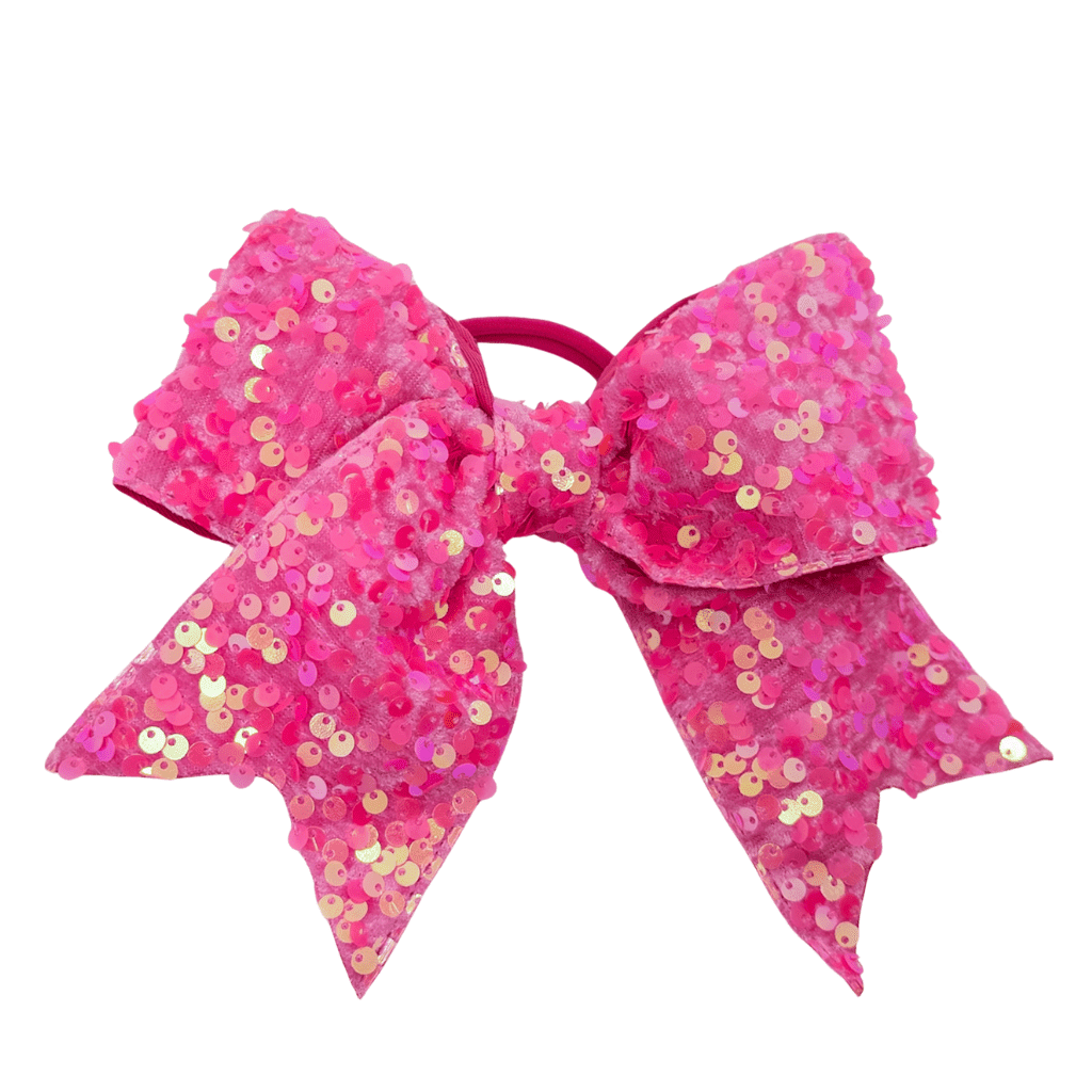 Pink sequin hair bow on a white background