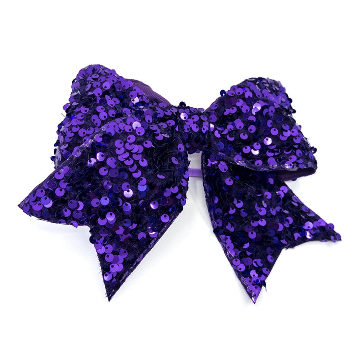 Purple sequin bow on a white background