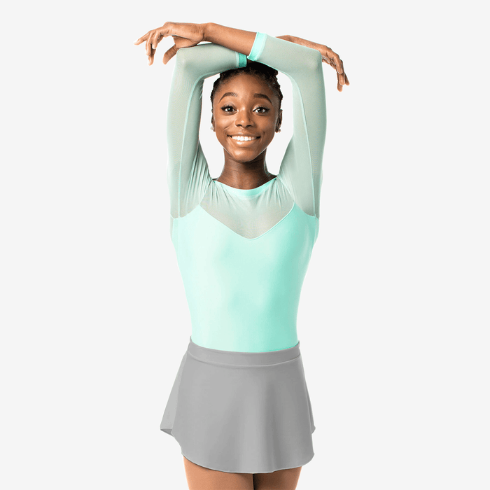 Person wearing a light blue top and gray skirt on a white background