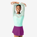 Young girl in a light green top and purple skirt posing against a white background