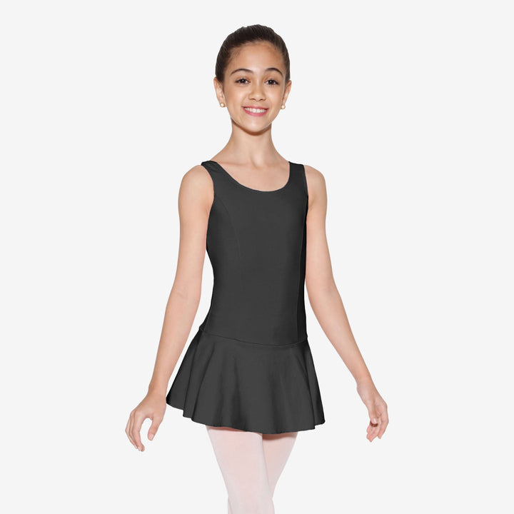 Young girl wearing a black sleeveless dress with a skirt on a white background