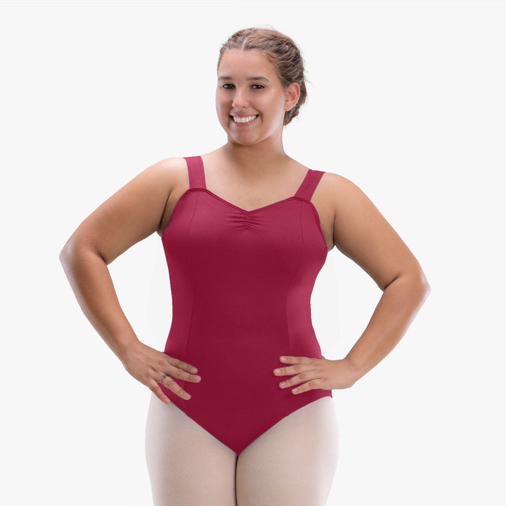 Woman wearing a maroon leotard on a white background