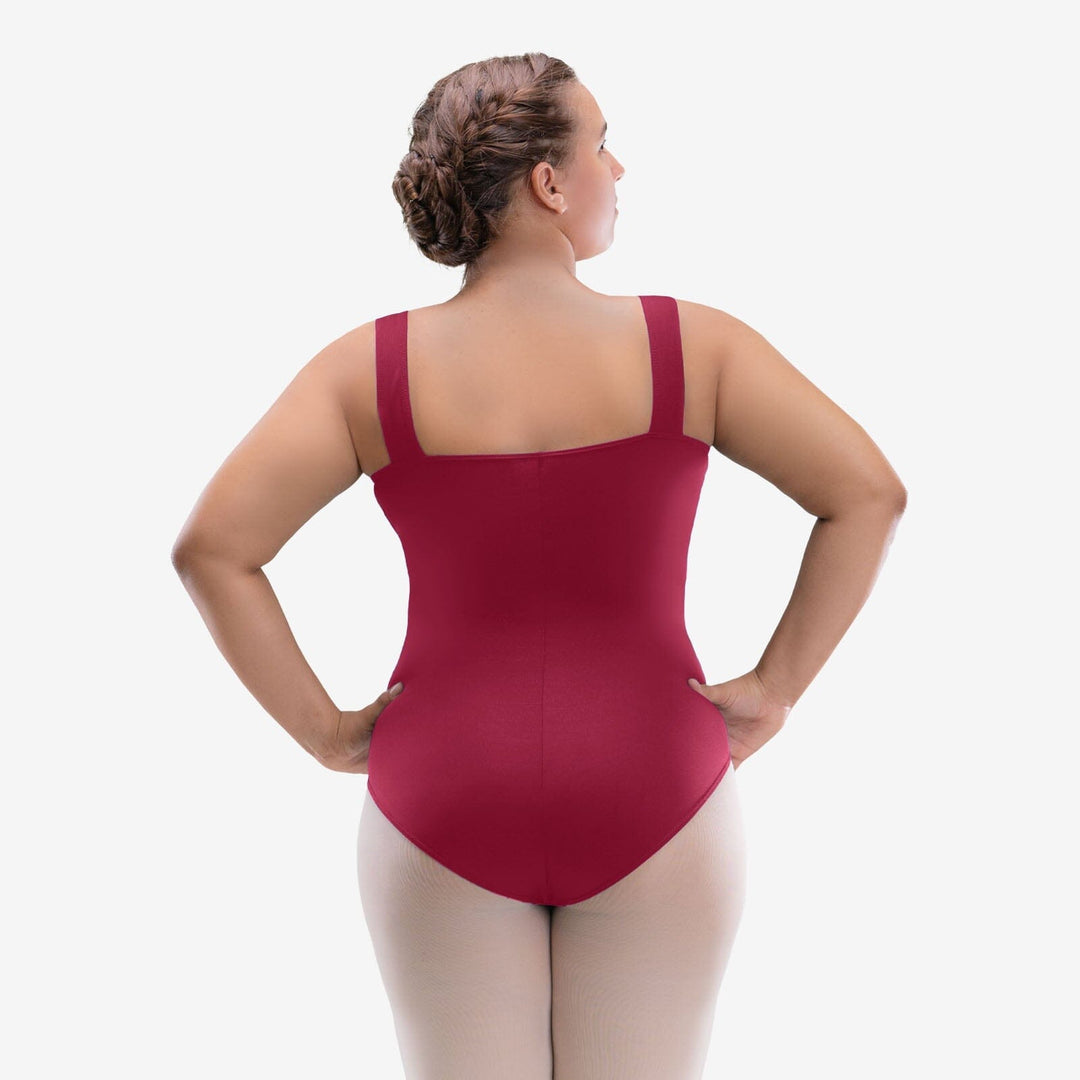 Woman wearing a red leotard on a white background
