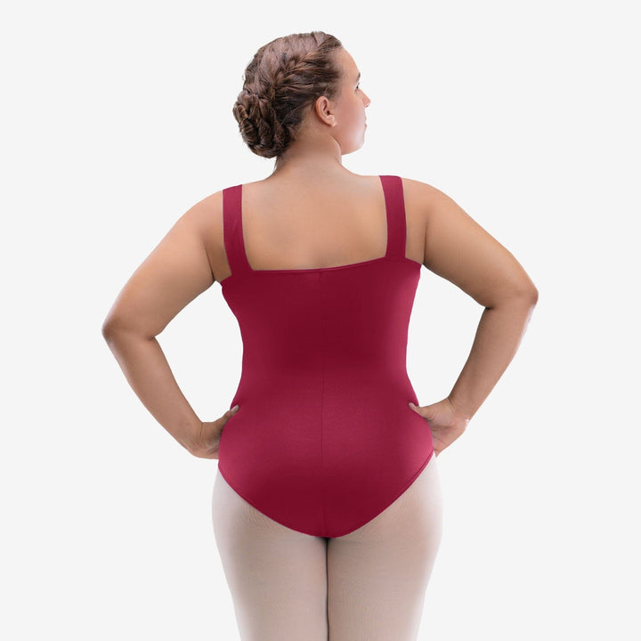 Woman wearing a red leotard on a white background