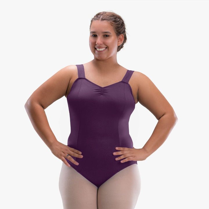 Woman wearing a purple leotard on a white background