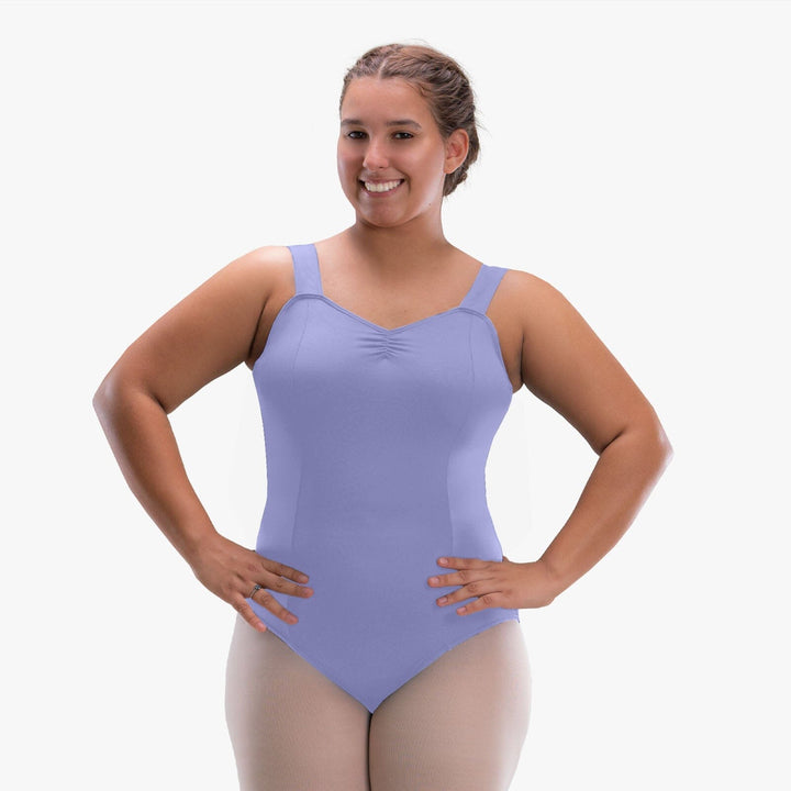 Woman wearing a purple leotard on a white background