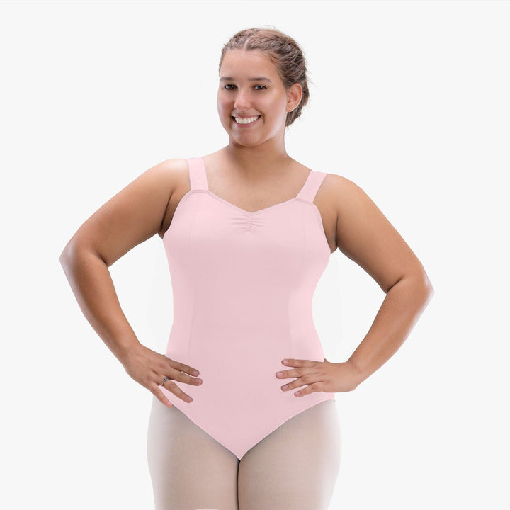 Woman wearing a pink leotard on a white background