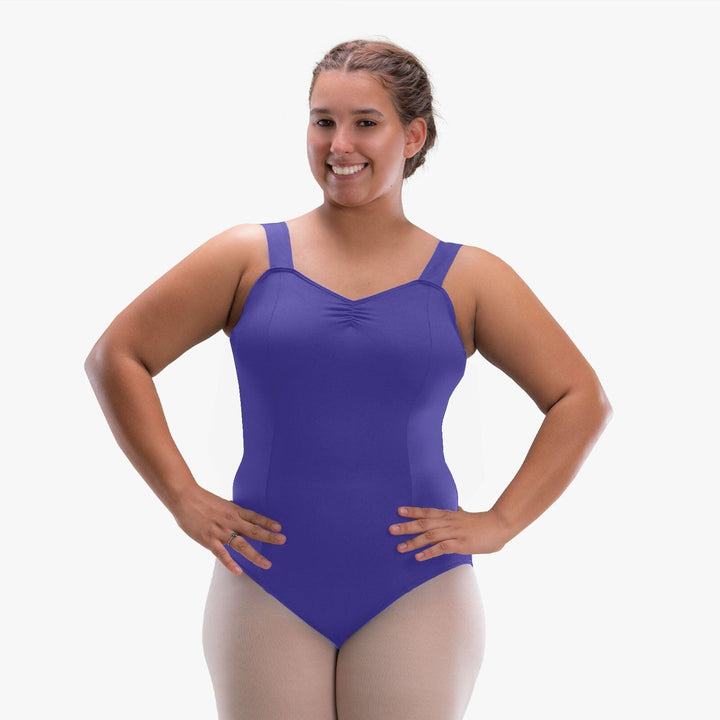 Woman wearing a purple leotard on a white background