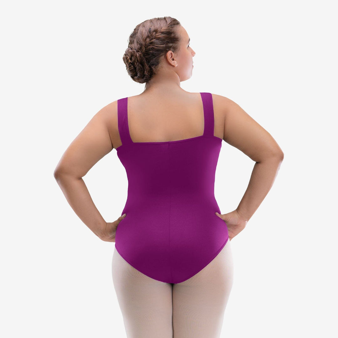 Woman wearing a purple leotard on a white background