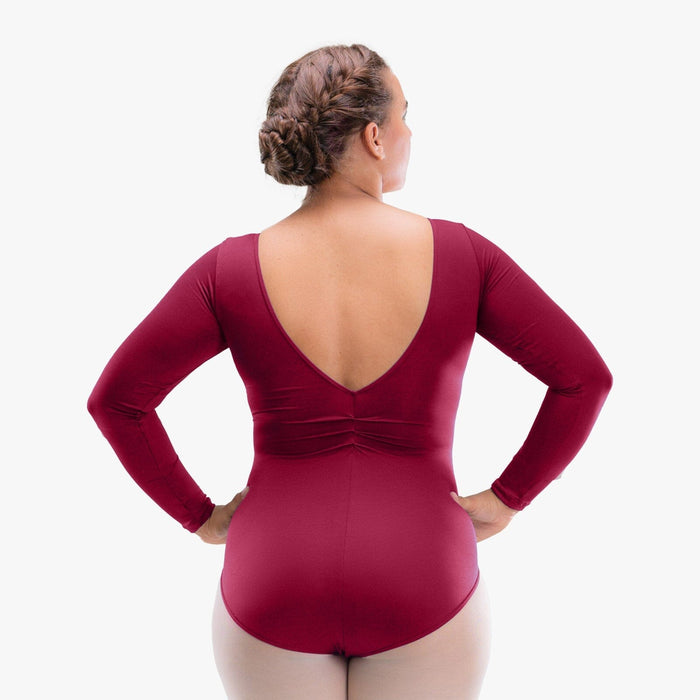 Person wearing a maroon bodysuit with long sleeves on a white background