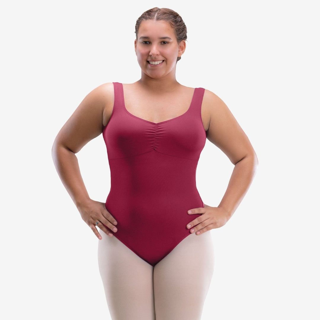 Woman wearing a maroon leotard on a white background