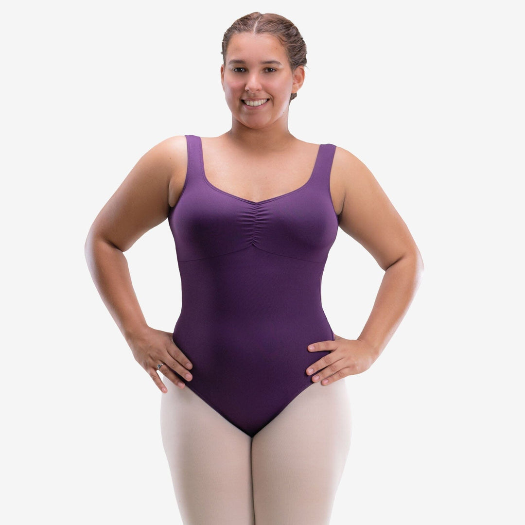 Woman wearing a purple leotard on a white background