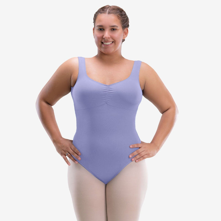 Woman wearing a purple leotard on a white background
