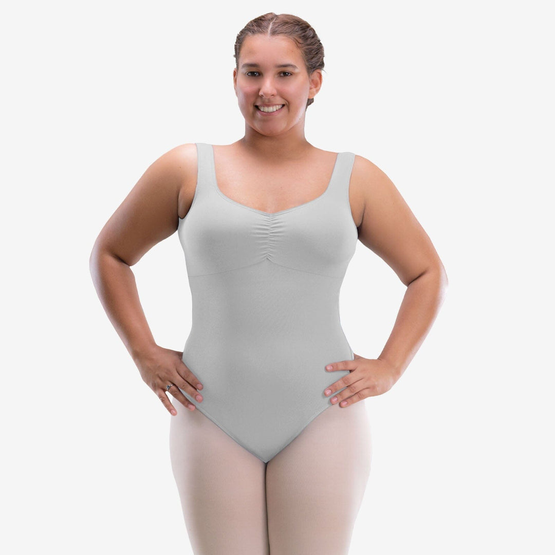 Woman wearing a light gray tank top against a white background
