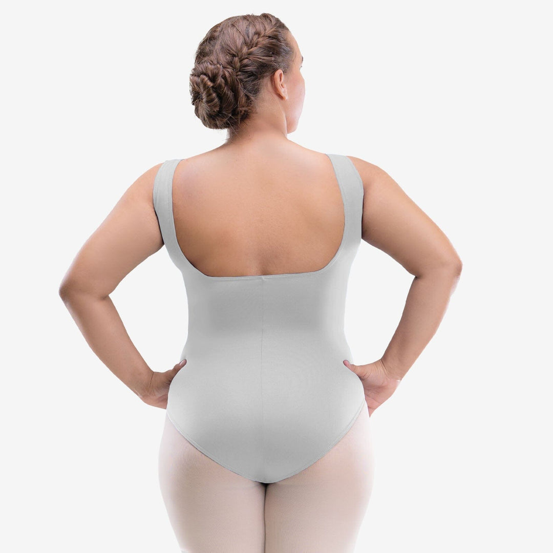 Person wearing a light gray bodysuit against a white background
